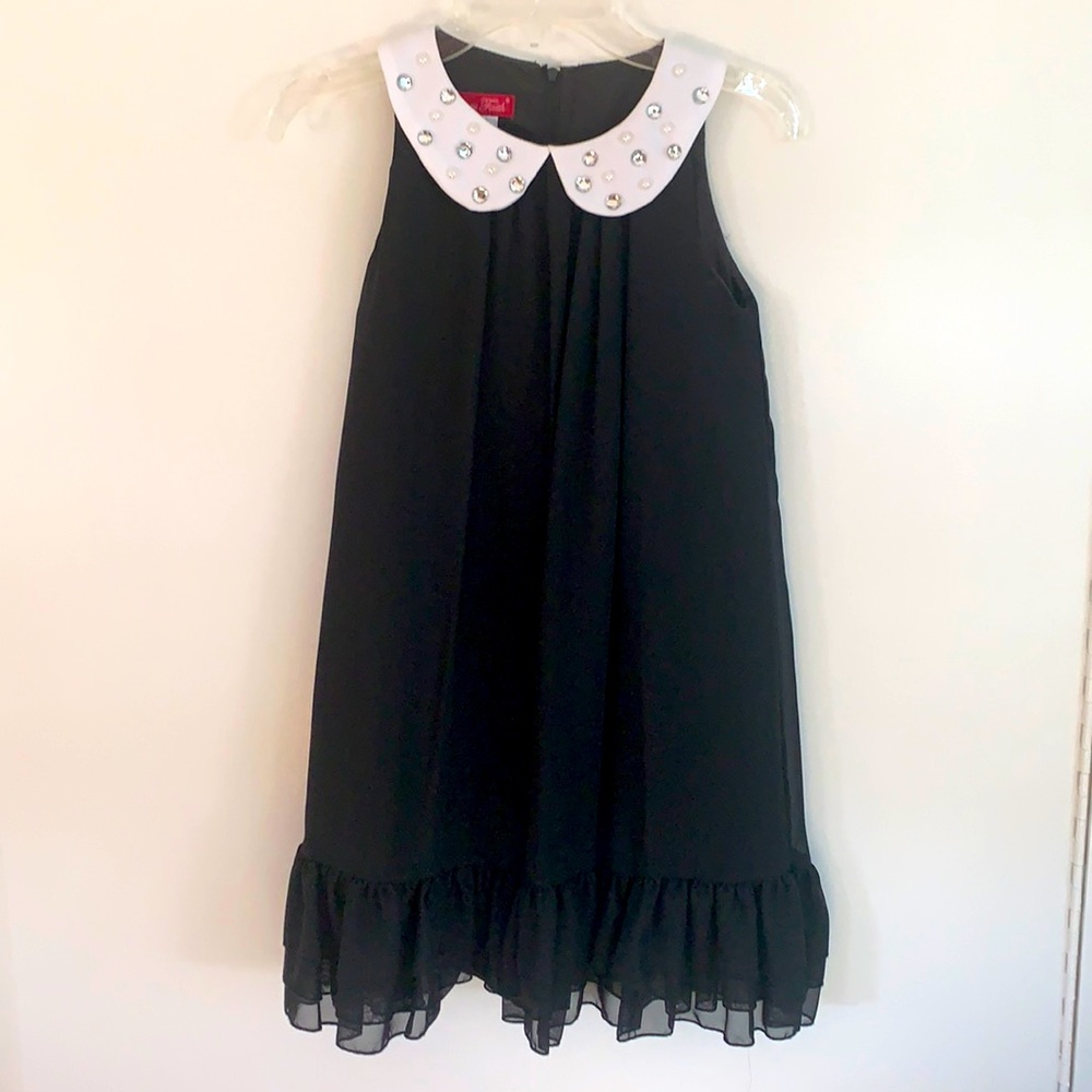 Classy black, pleated A-line dress with layered ruffles at the hem.